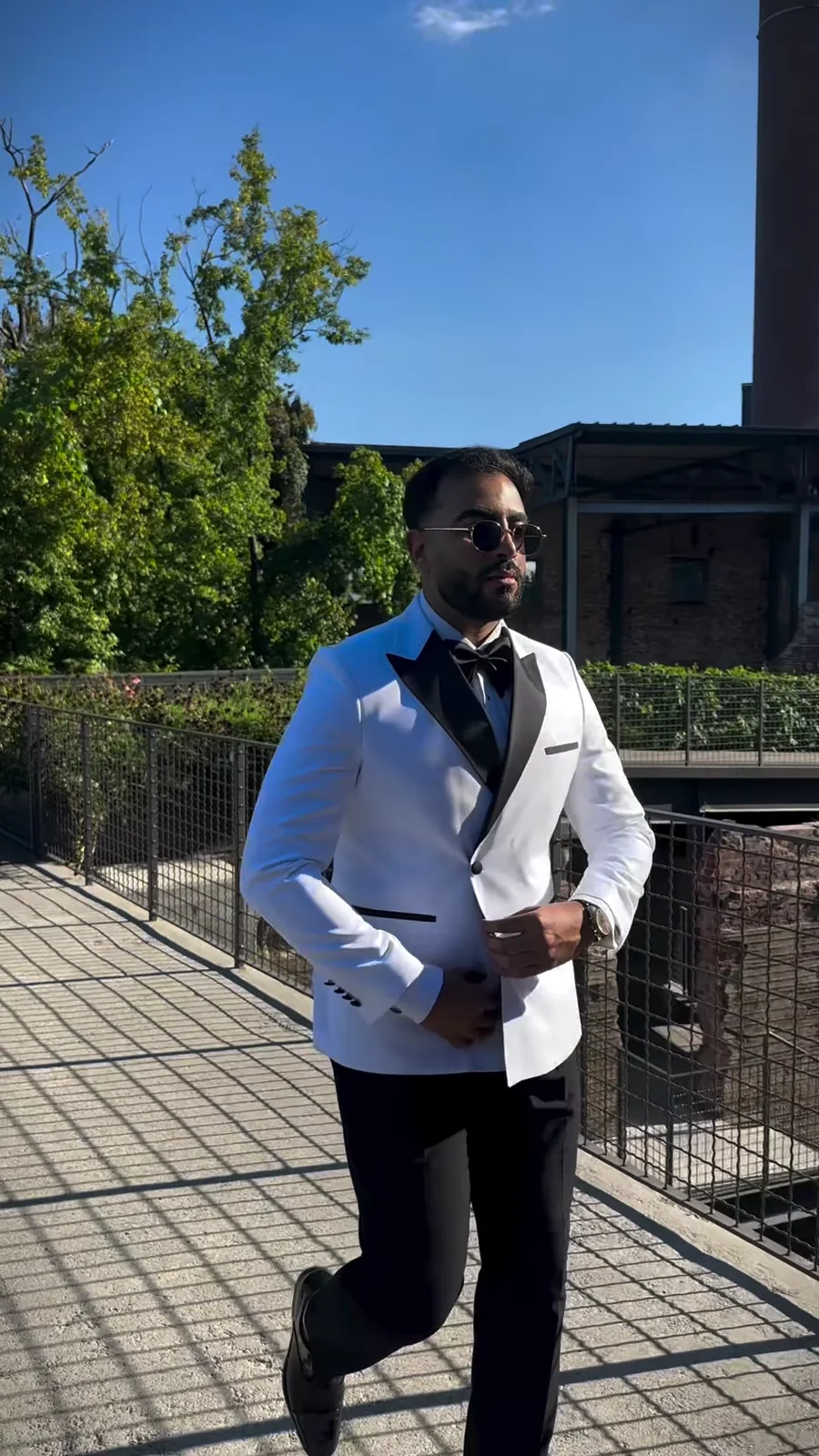 Omar wearing a white tuxedo in the Italian Collection Instagram reel